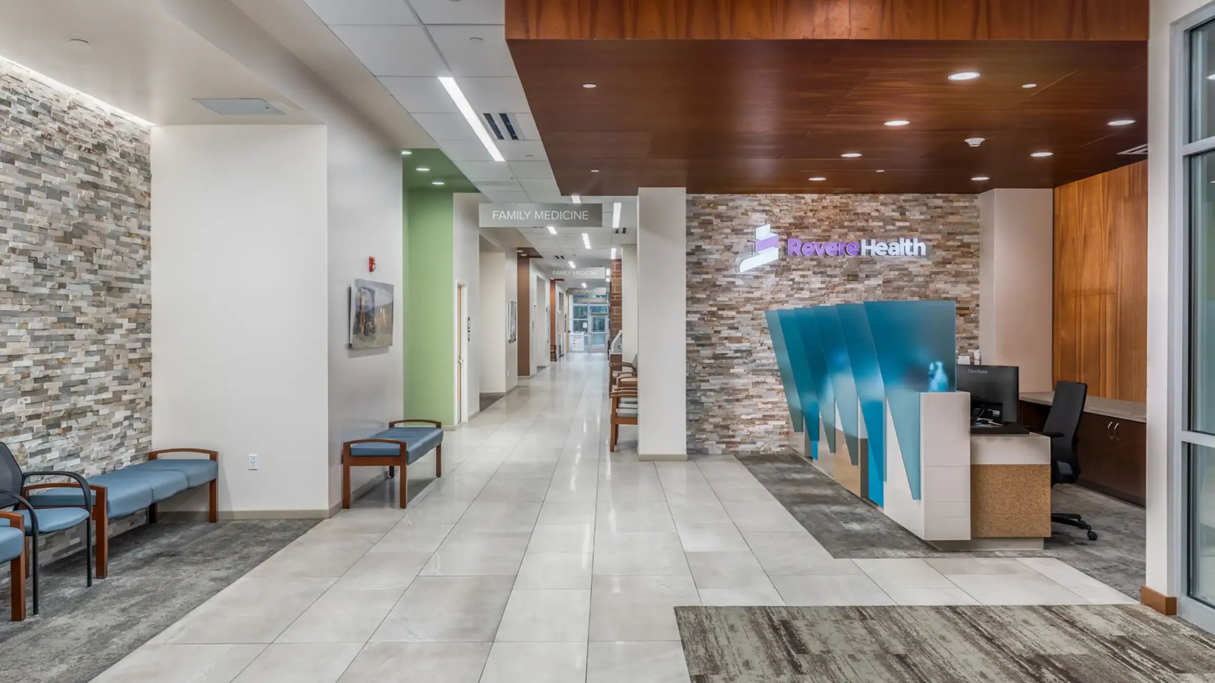 Healthcare clinic lobby with stone accent wall and reception desk