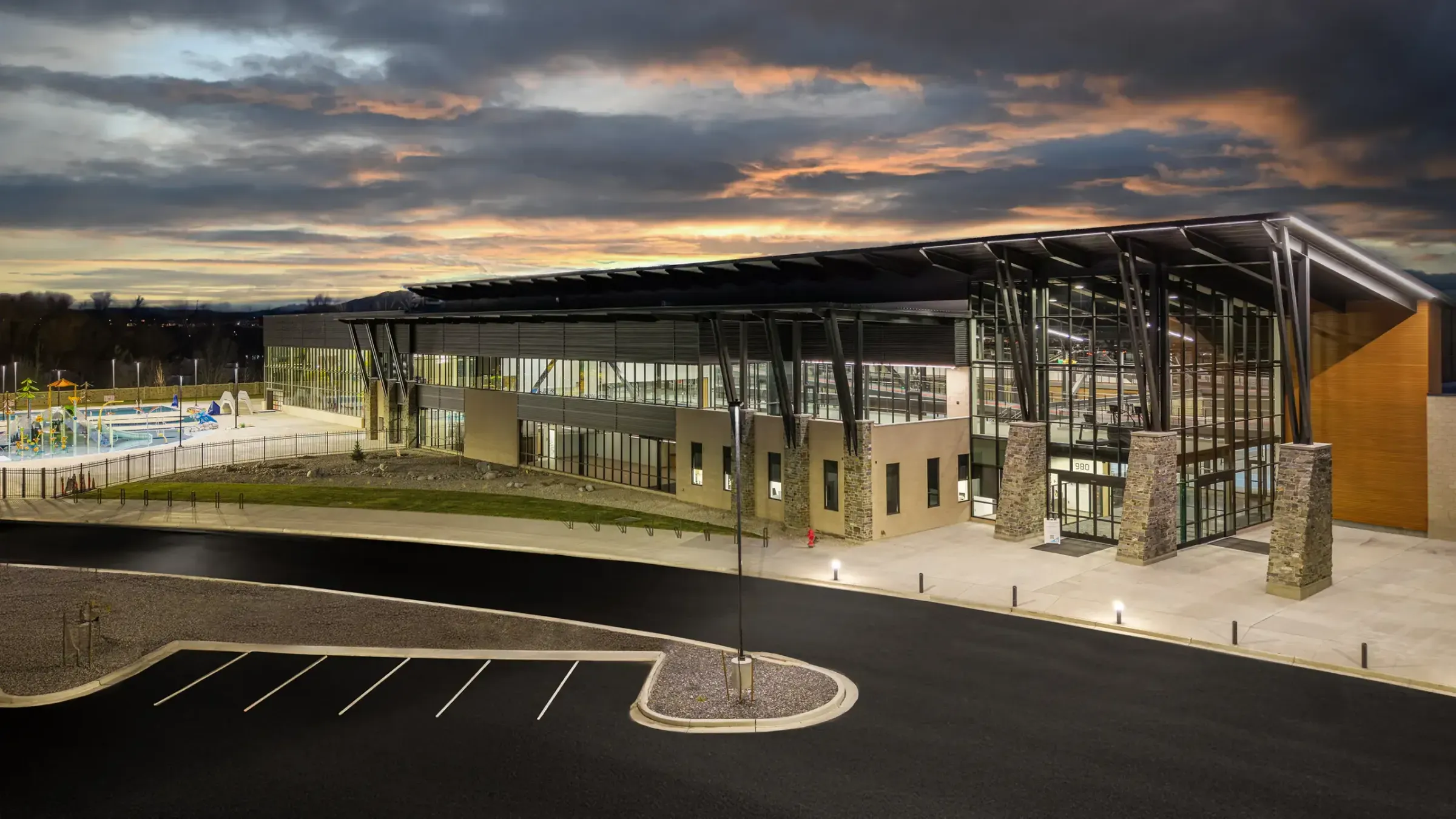 Spanish Fork FitCity Recreation Center and its outdoor pool at dusk