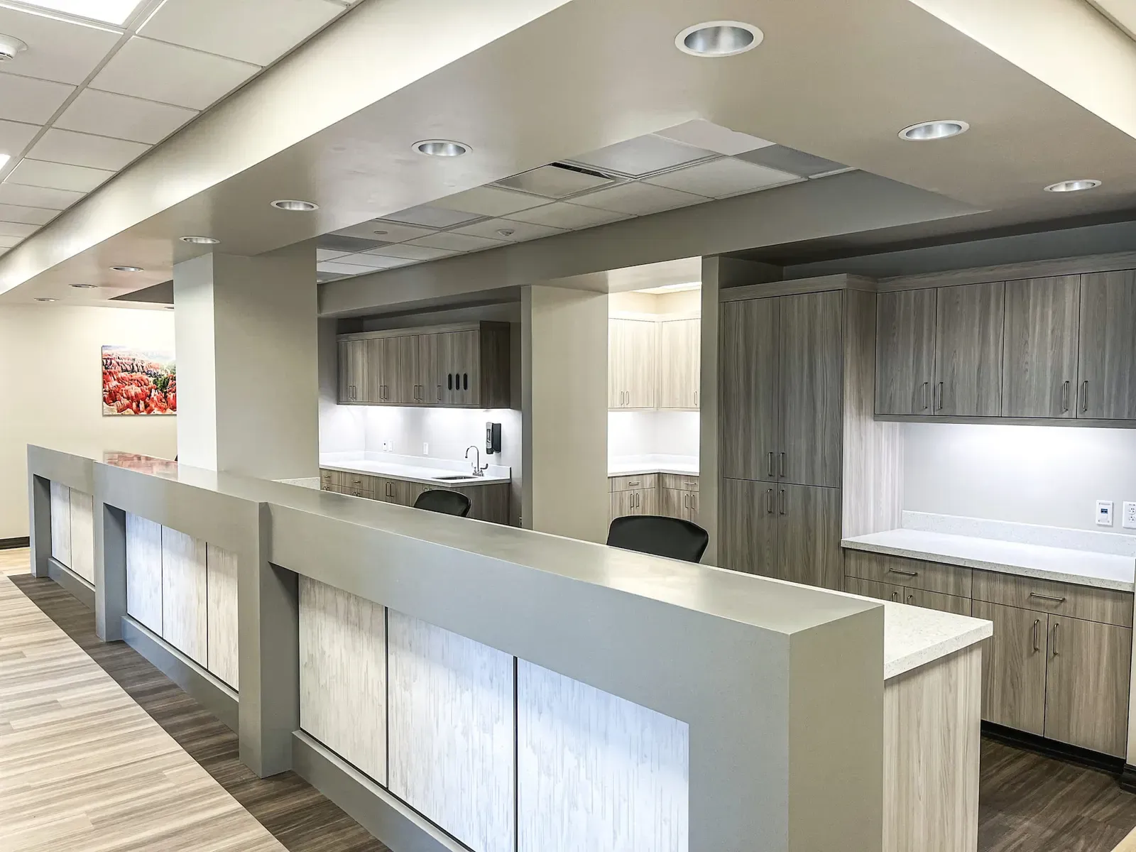 Long reception counter with wood-look cabinets behind it