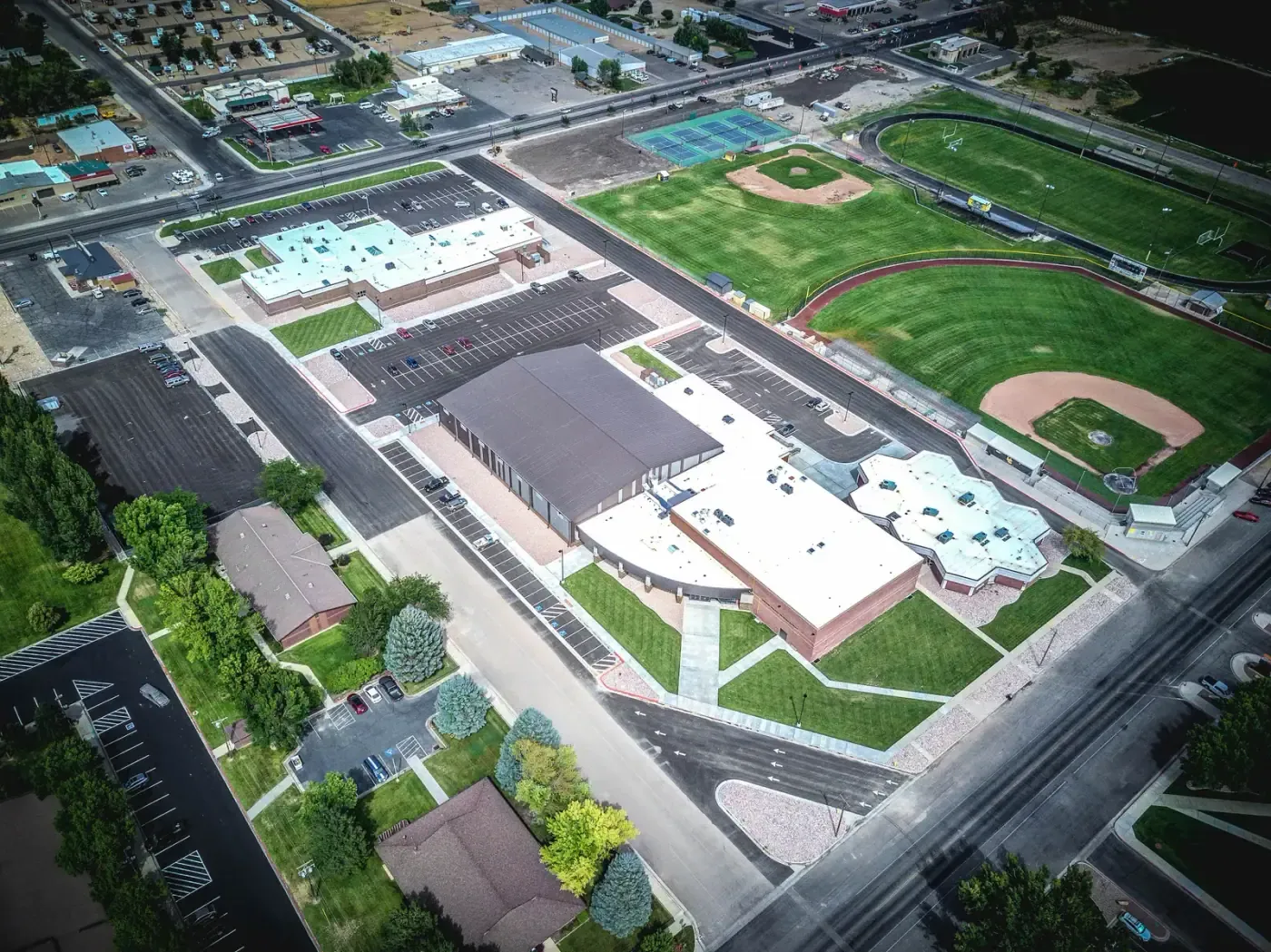 Aerial view of the campus with several buildings, parking lots and baseball and track fields