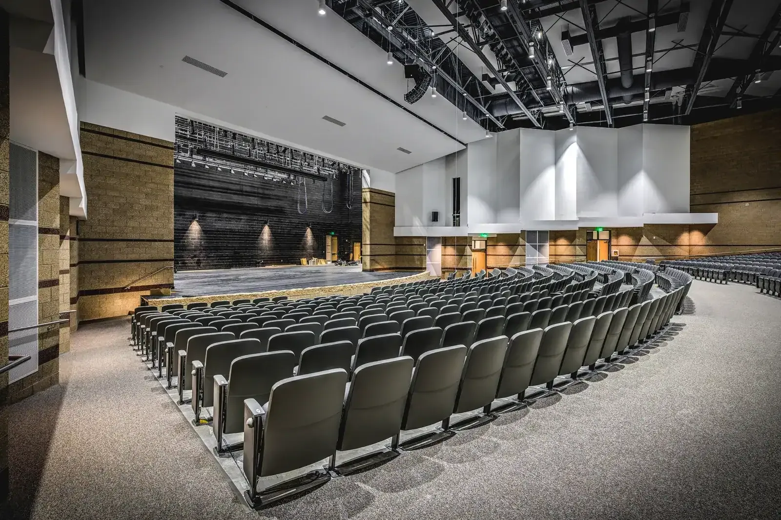 Auditorium with curved rows of seating facing the stage.