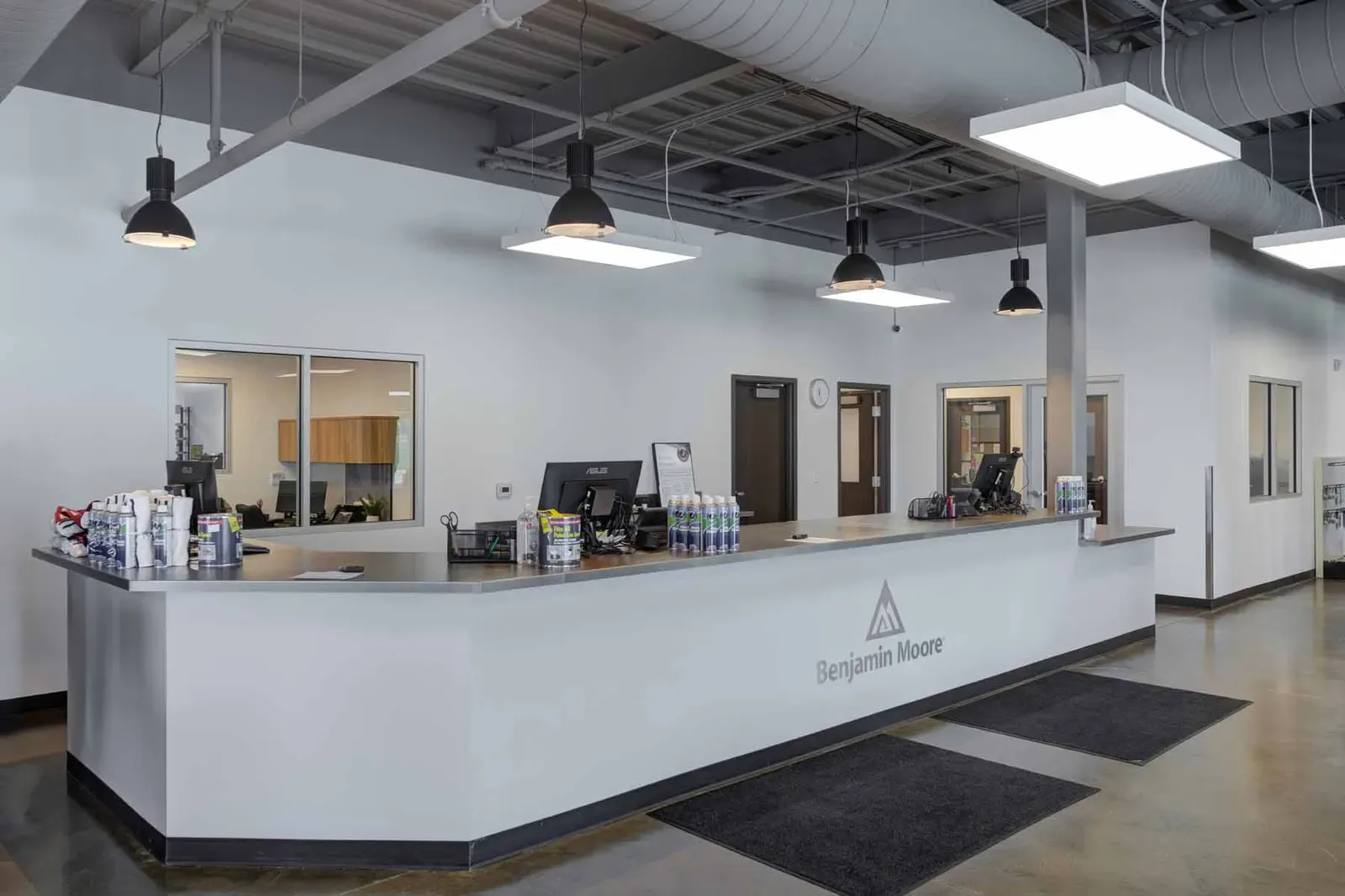 Service counter with a Benjamin Moore logo and black pendant lights