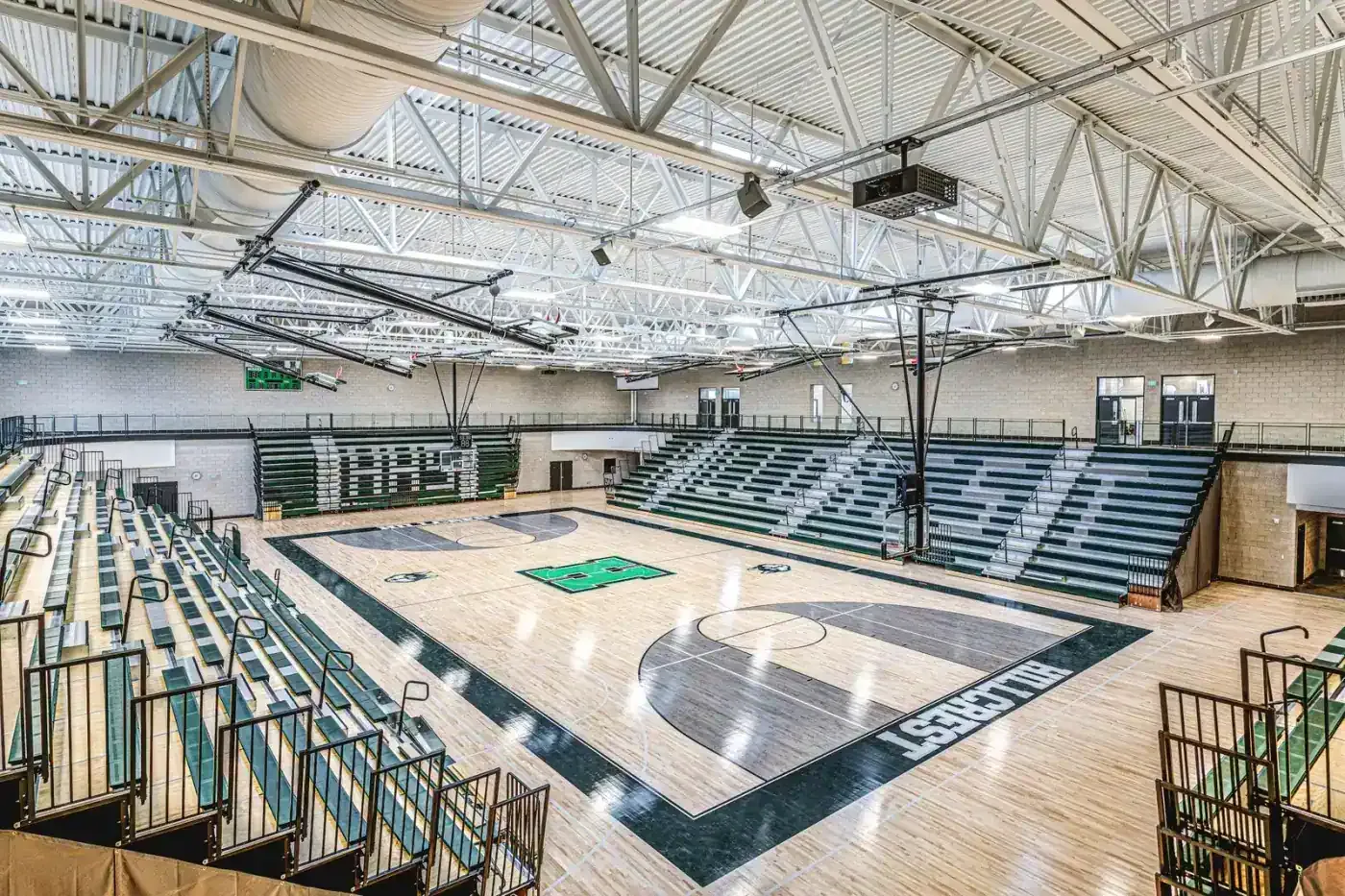 Gymnasium with a hardwood floor, Hillcrest lettering and tiered seating