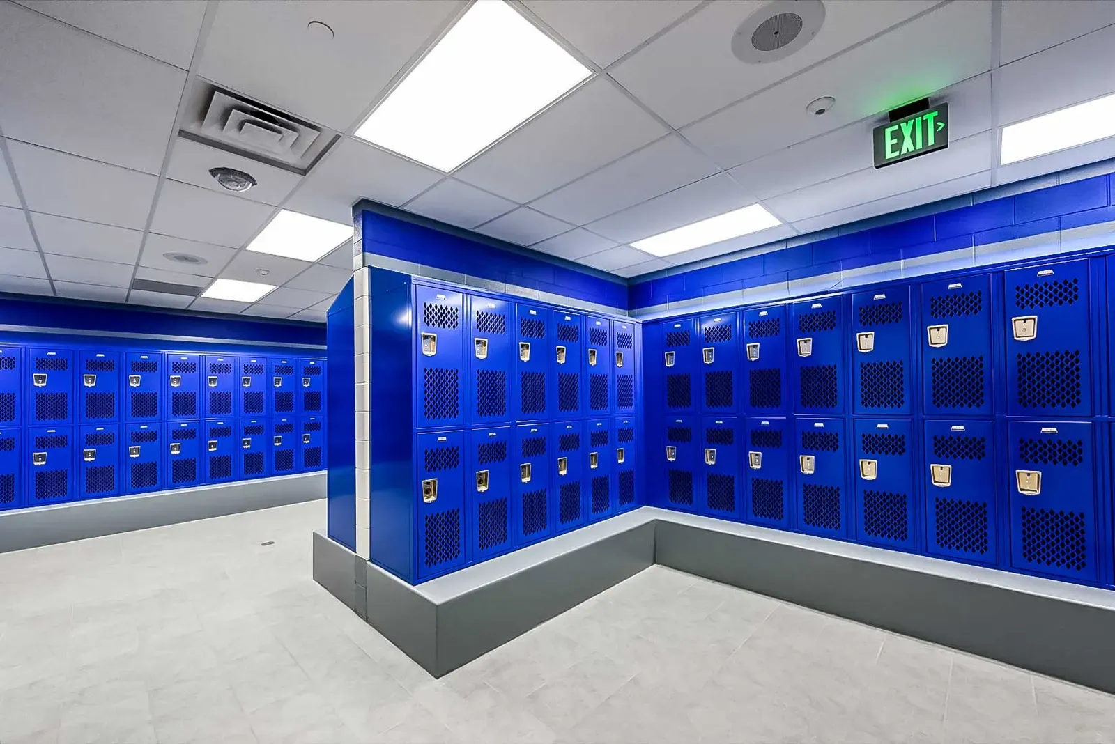 Locker room with rows of blue lockers on a gray base.