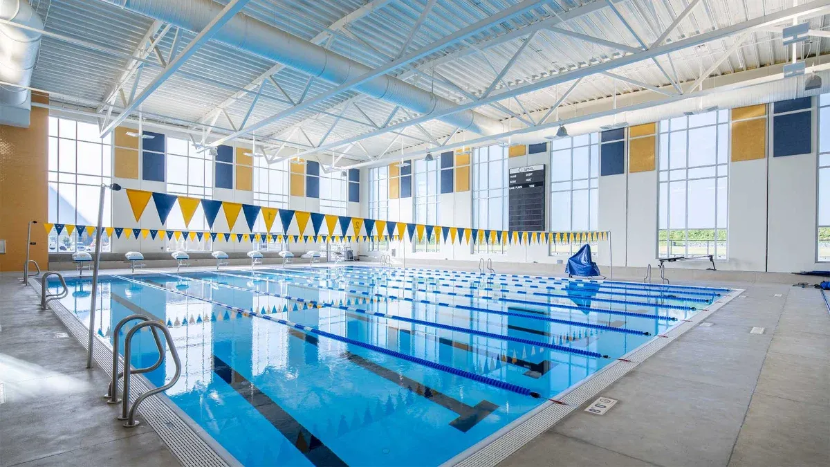 Indoor competition pool with lane lines and pennant flags overhead