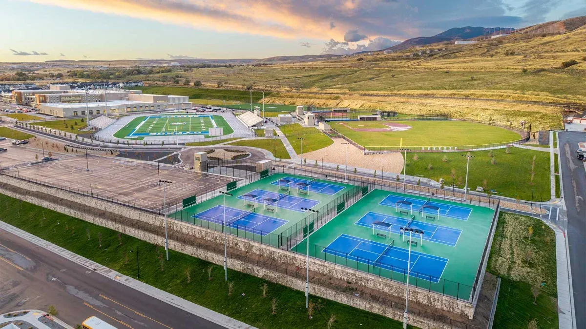 Aerial view of the campus tennis courts and athletic fields with mountains behind