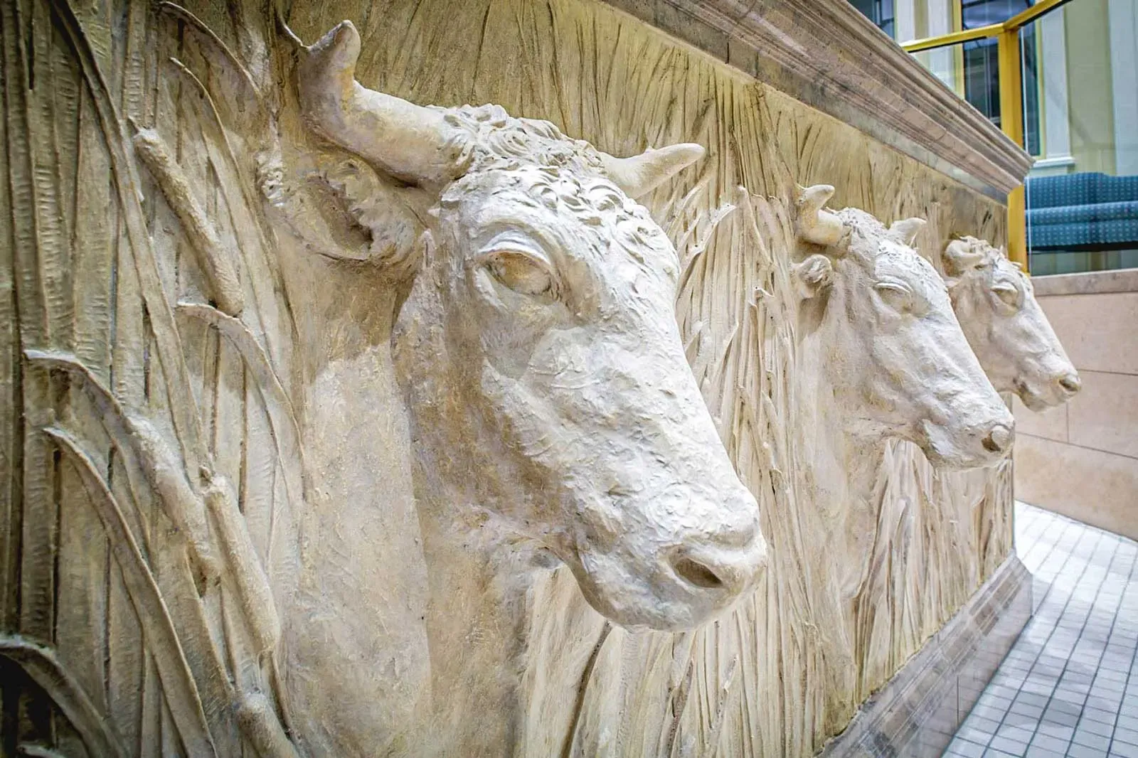Carved stone relief of oxen heads set into a wall.