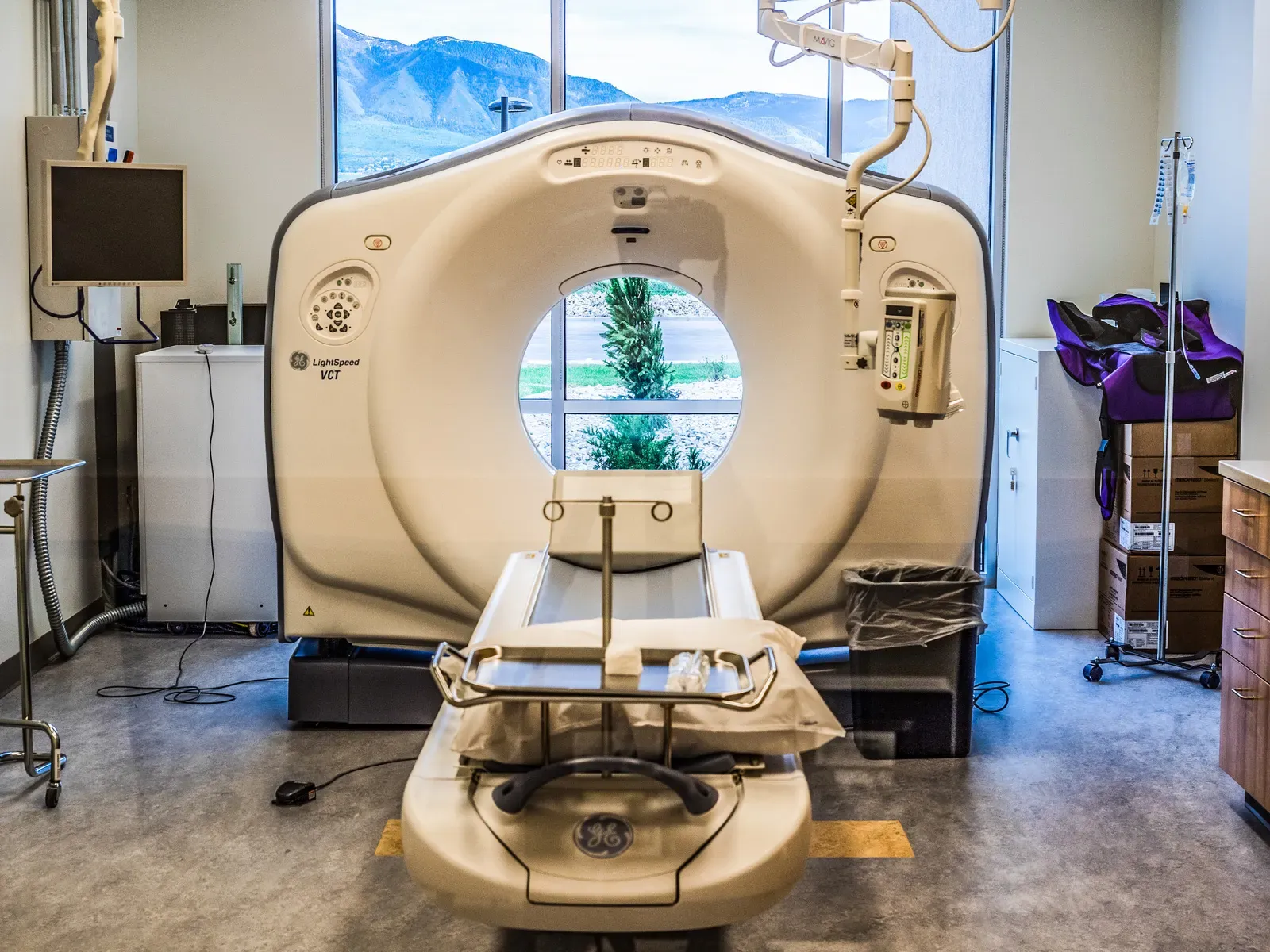 CT scanner in an imaging room with a window onto the mountains.