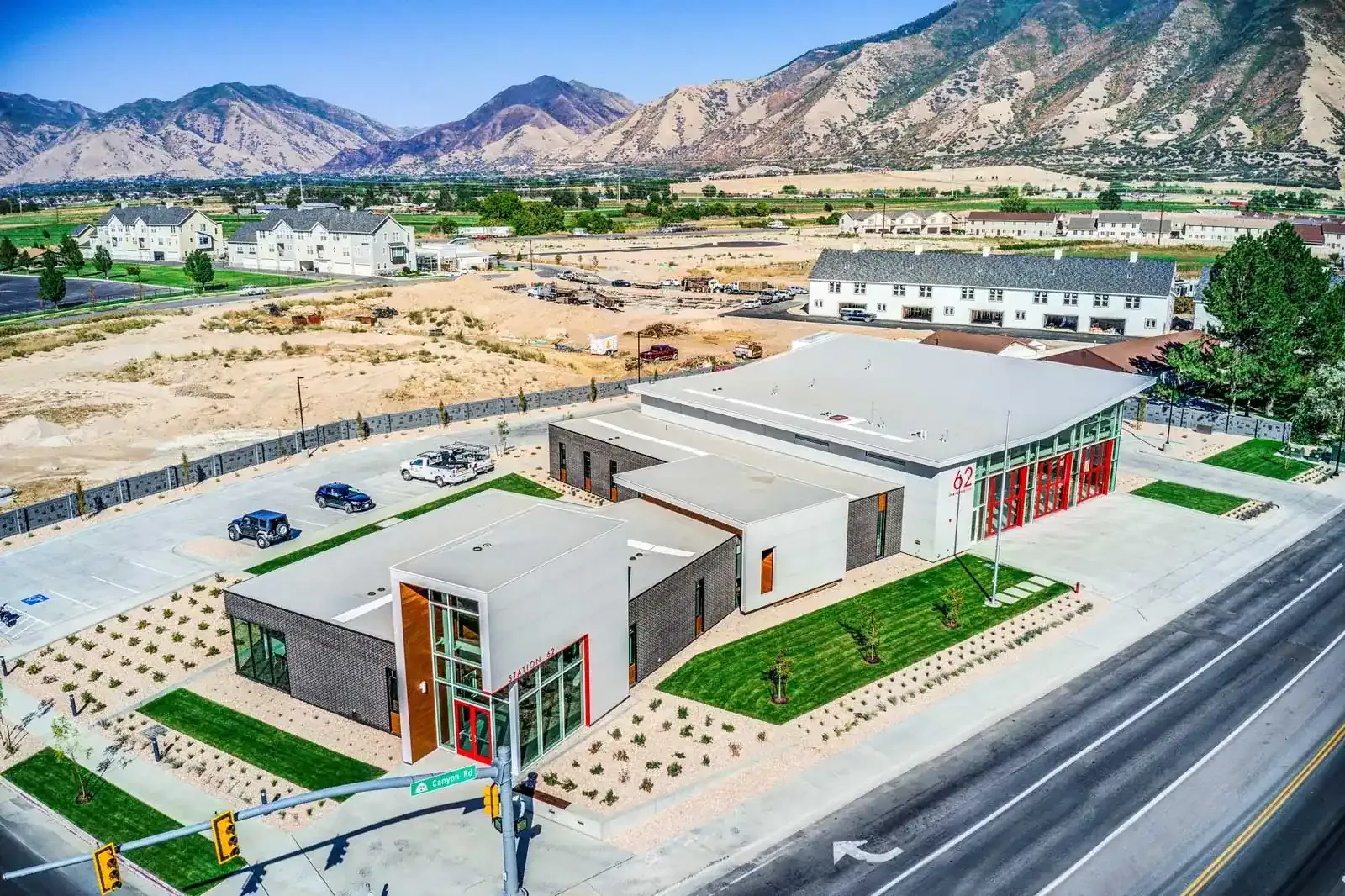 Aerial view of the fire station on a corner lot with mountains in the background.