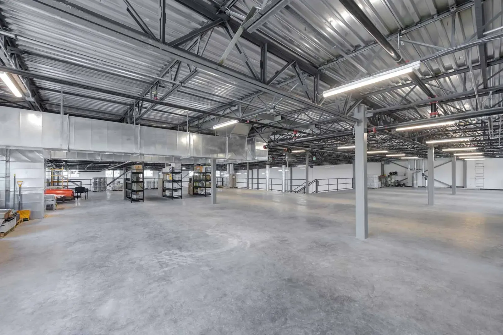 Open mezzanine level with steel columns and a metal roof deck