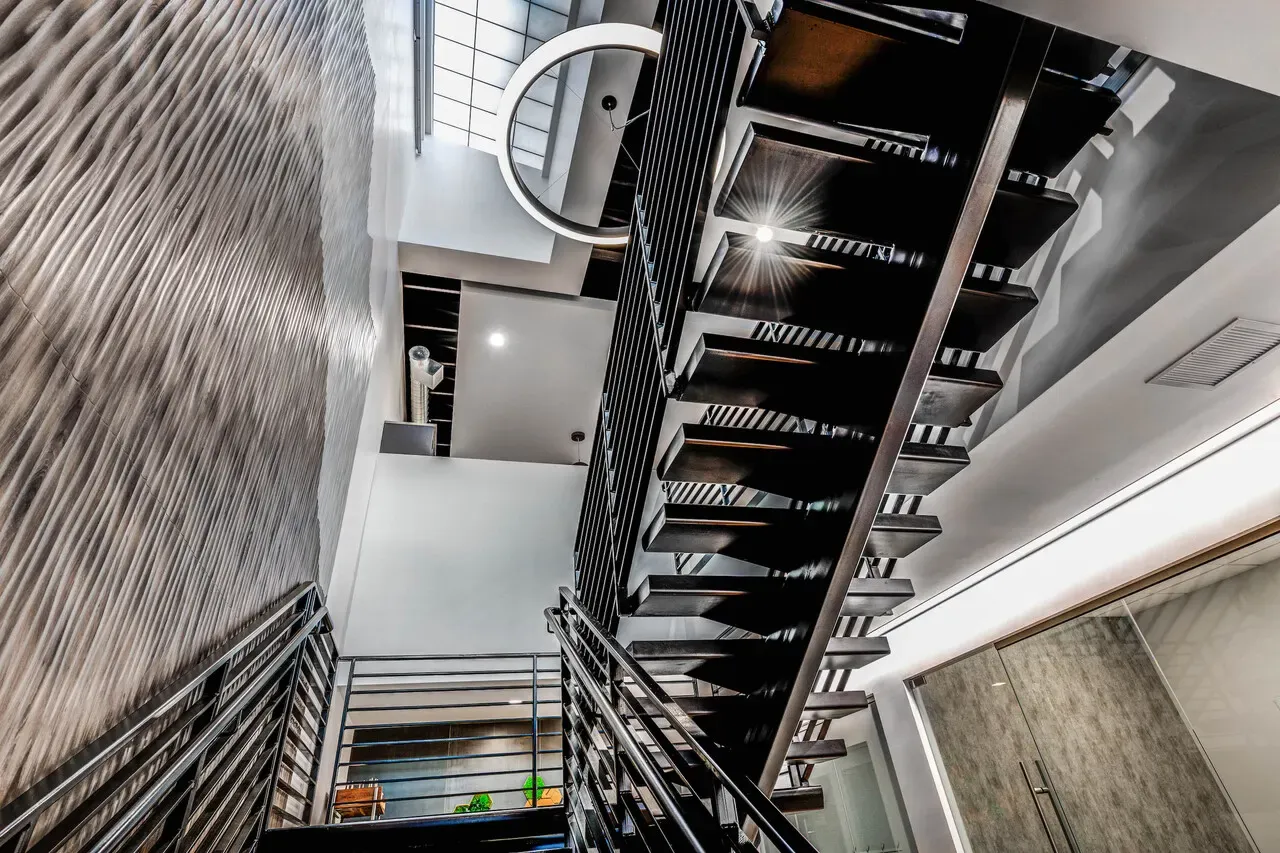 Looking up the open steel staircase through the building's stairwell