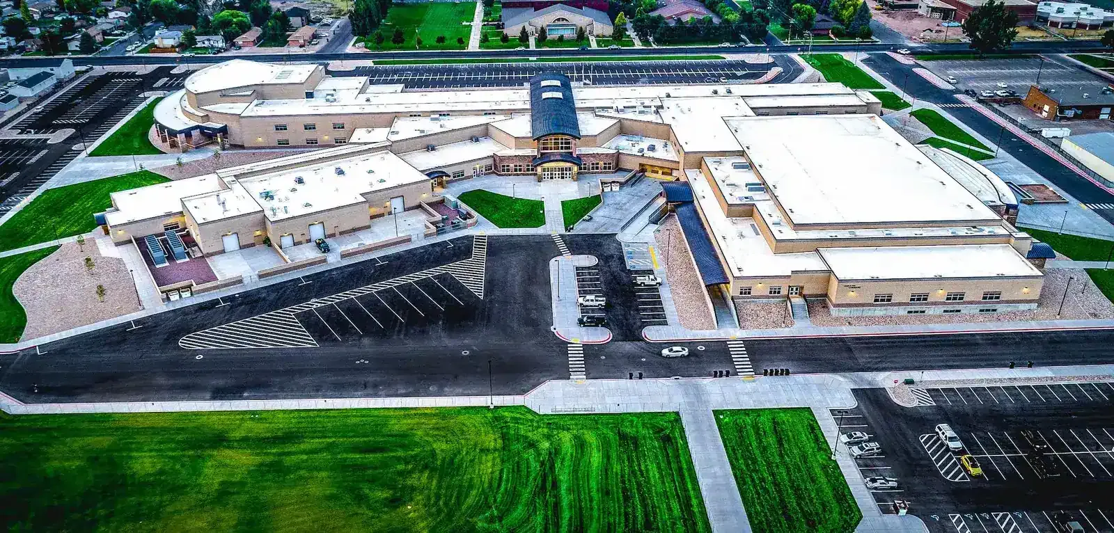 Aerial view of the school building, parking lots and surrounding grounds.