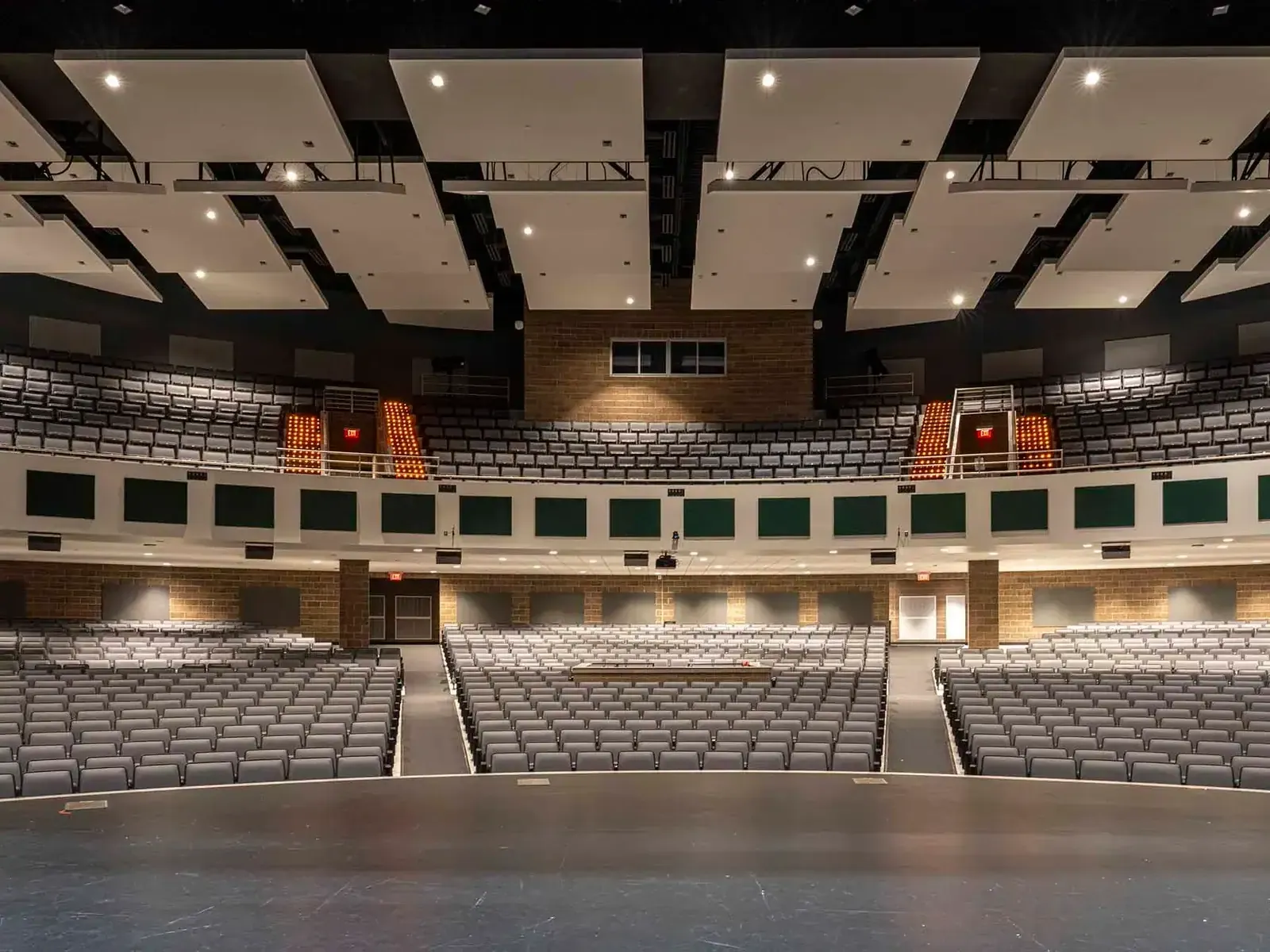View from the stage across the performing arts auditorium's main floor and balcony seating