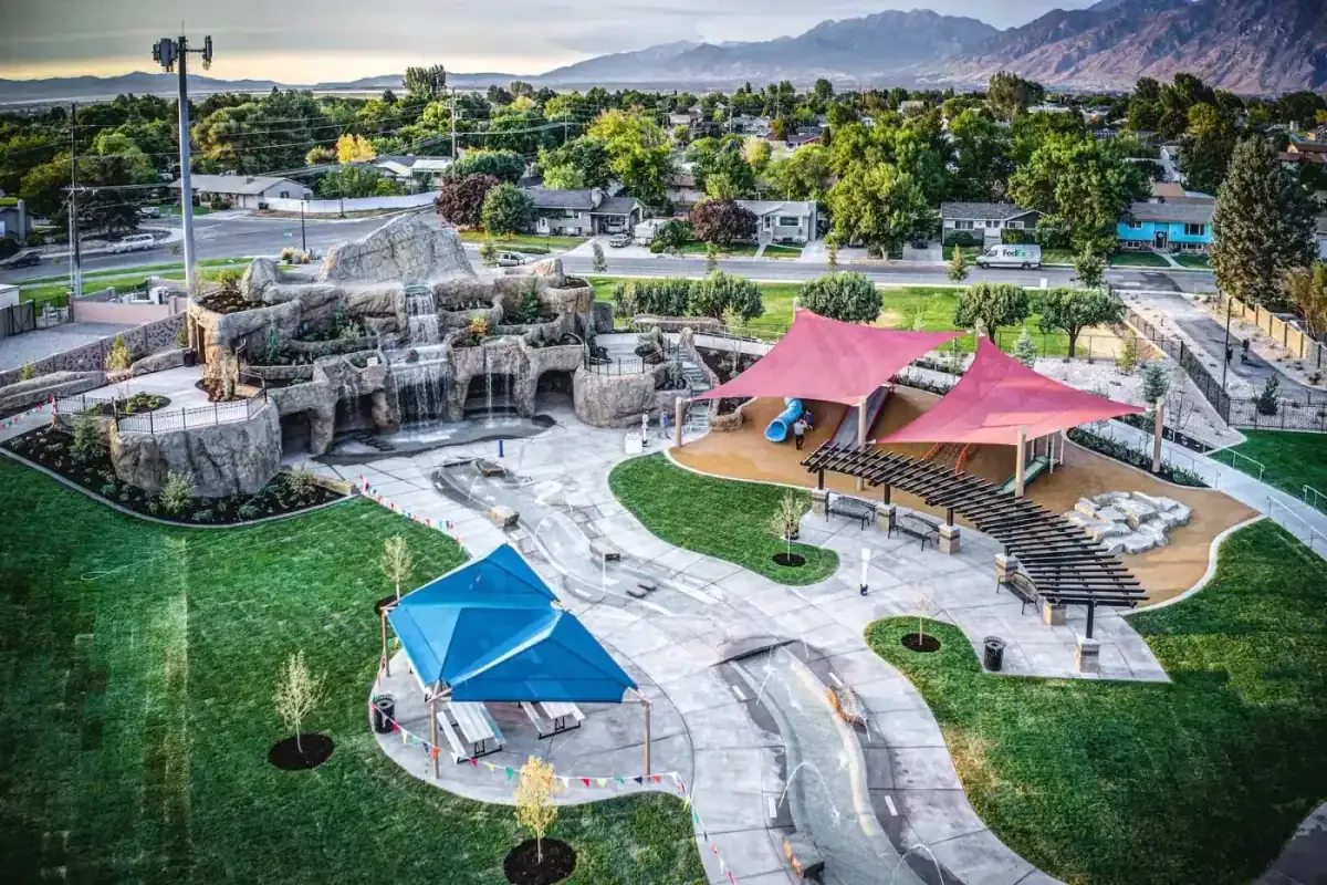 Aerial view of the rock waterfall feature, shade sails and splash area beside neighborhood streets