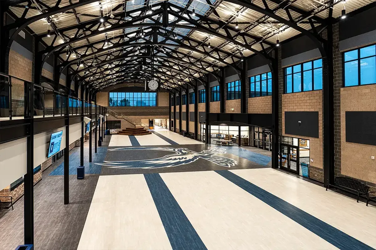 Deer Creek High School commons, a long skylit hall with exposed steel trusses