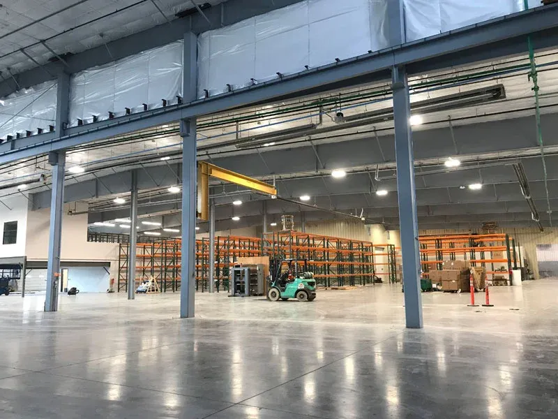 Warehouse interior with steel columns, a polished concrete floor, and pallet racking
