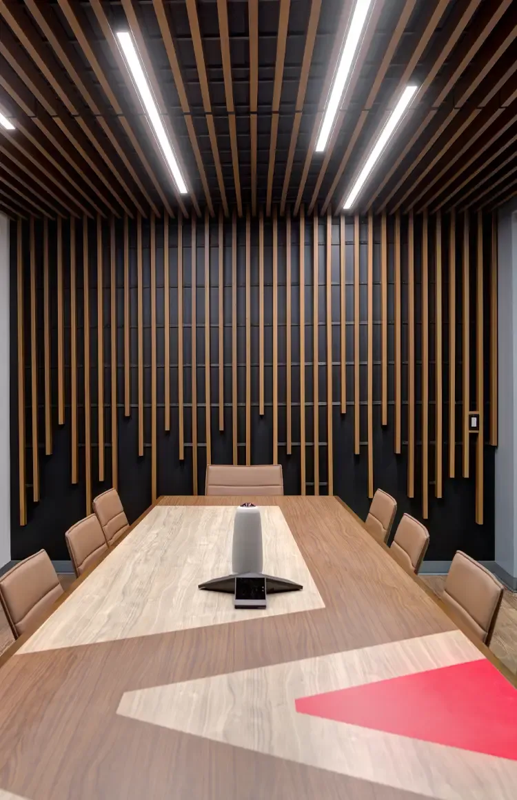 Boardroom with a long timber table under a slatted wood ceiling