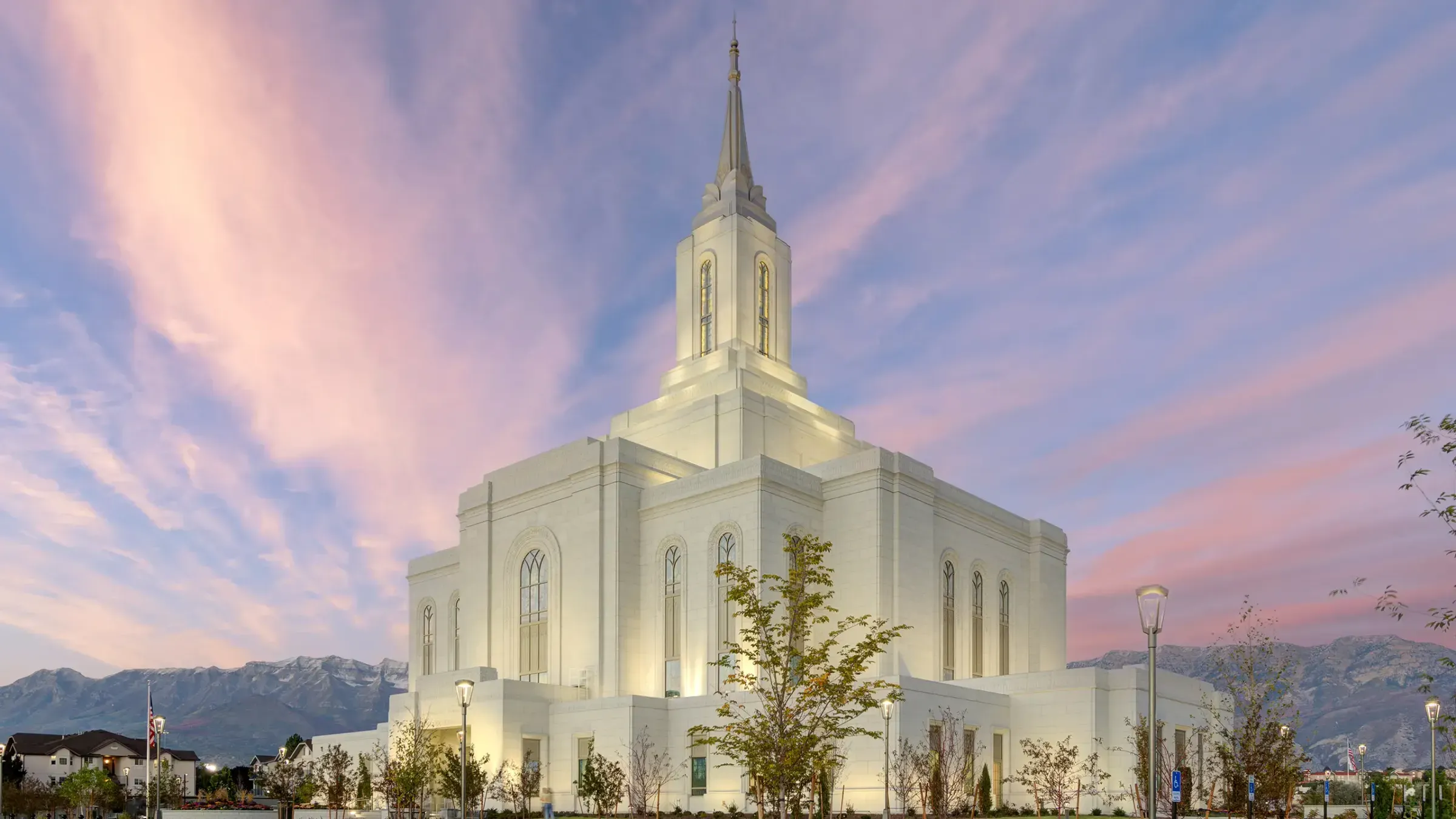 Orem Utah Temple lit at dusk under a pink and blue sky